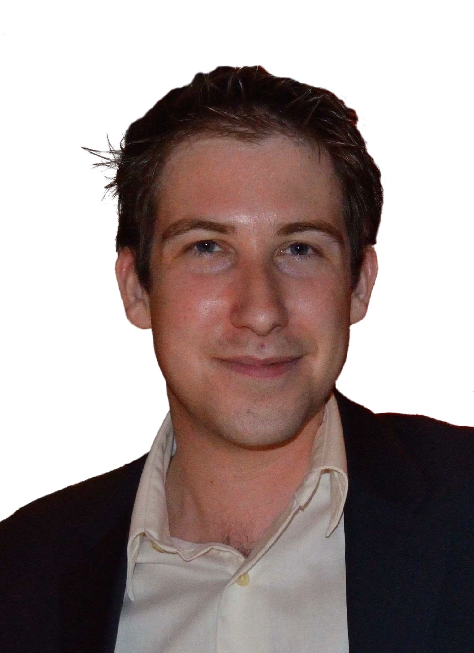 Portrait of a smiling young man with short dark hair, wearing a black suit jacket and cream shirt, set against a plain white background.